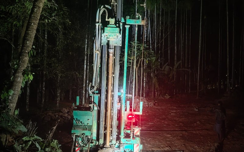 Deep commercial borewell drilling operation conducted at night with floodlights in Nileshwar, Kasaragod